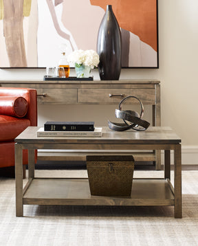 Origins by Stickley side console table with black decorative vase and white flowers and matching coffee table with books on top