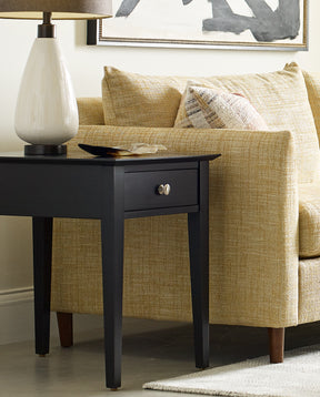 Origins by Stickley side table next to beige fabric couch